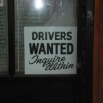 Sign by taxi office : Drivers wanted, Inquire within